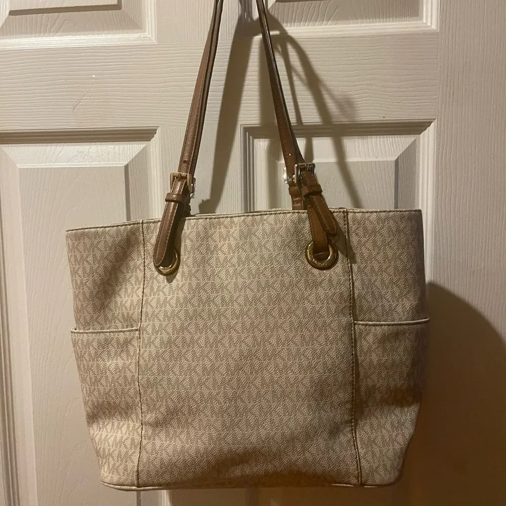 Michael Kors Beige signature Coated Canvas tote , tan leather straps .